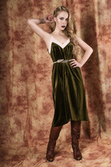 Naklejka premium Beautiful fashion model in a velvet green dress. Vintage. Luxury style.