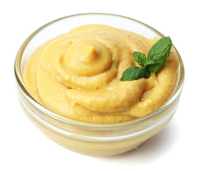 glass bowl of mustard isolated on white background
