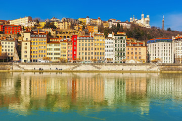 Facades of colorful traditional old houses along riverside, Lyon, France.