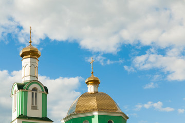 Fototapeta na wymiar Church domes on the sky background
