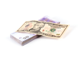 Dollar banknote and stack of ukrainian money