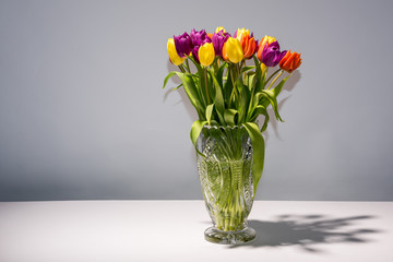 Bouquet of tulips in a glass pot