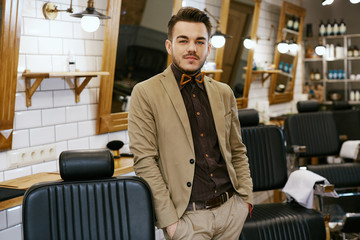 Portrait of handsome man at barbershop background