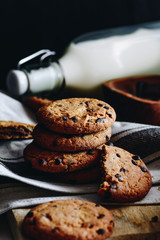 Sweet homemade cookies with pieces of chocolate. Bottle of milk.