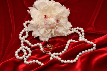 Two wedding rings and Peony flower.