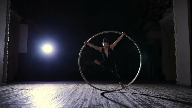 Circus artist training with a big hula hoop