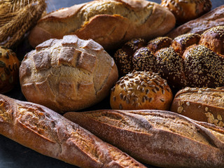 Different kinds of bread on background.