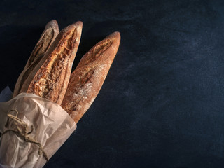Three freshly baked baguettes on the table.