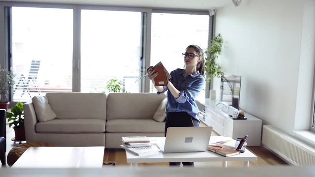 Female designer with fabric sampler working from home.