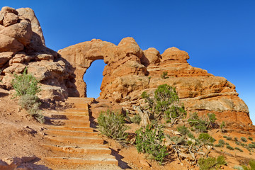 Allure of steps leading up to Turret Arch framed against blue sky © F&J McGinn