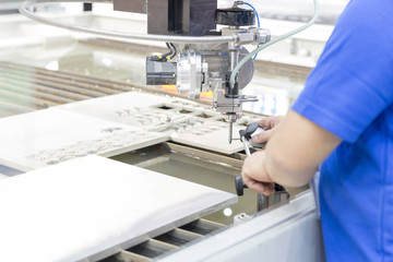 The technician operator using the dial gauge for calibration the water jet machine.hi-precision...