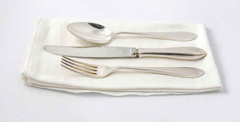 Silverware on white napkin