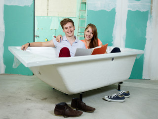 Couple celebrate her new bathtub in a building lot