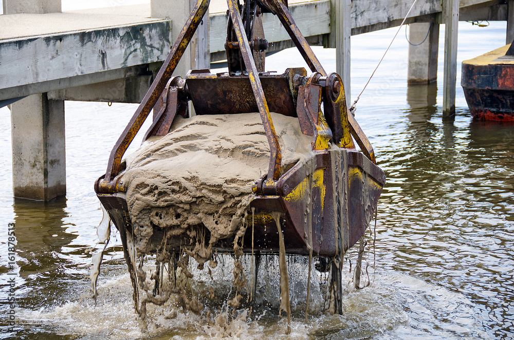 Wall mural dredger bucket dredging lake bottom in marina