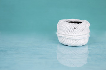 White cotton string ball with space on blue background, 