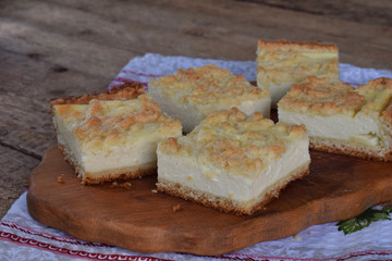 Homemade cottage cheese pie. Rustic grated cake bars on a wooden board