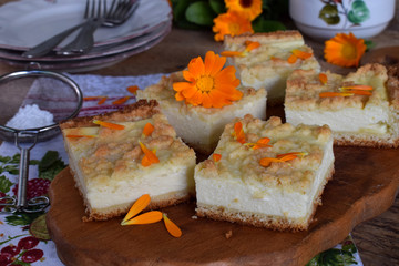 Homemade cottage cheese pie. Rustic grated cake bars on a wooden board
