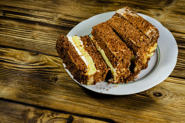 Biscuit cake in plastic container on wooden table