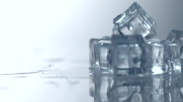 Ice cubes rotation 360 degrees. Closeup of melting Ice cube. 4K UHD video 3840X2160