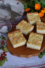 Homemade cottage cheese pie. Rustic grated cake bars on a wooden board