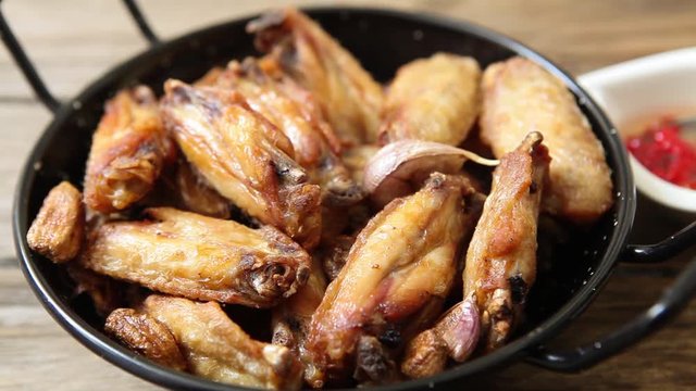 toping chicken wings with chili oil