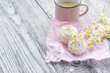 Cup of coffee, homemade marshmallow and jasmine branches