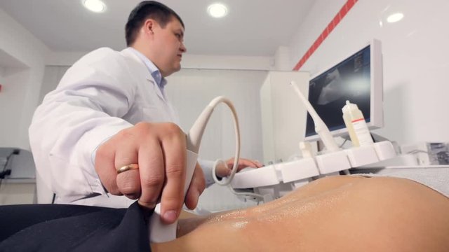 Aerial close up of ultrasound examination of the abdominal cavity 