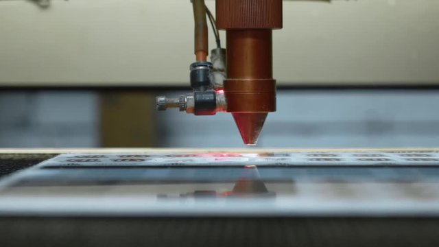 cnc Laser cutting machine at work. Acrylic plastic cutting. Close-up