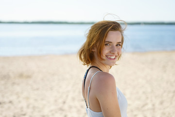 Attractive young woman turning to smile