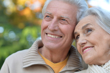 senior couple posing   in the park