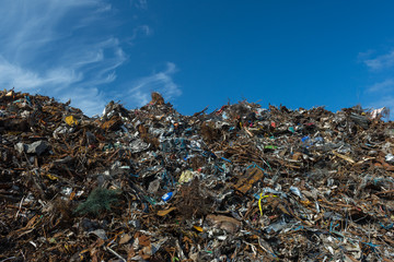 Scrap metal piled up and blue sky background