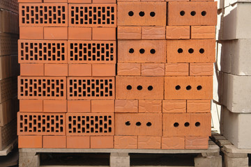 Clay brown bricks on construction market