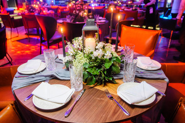 Served table in restaurant.Selective focus/Served table with flowers, candles and decor in restaurant