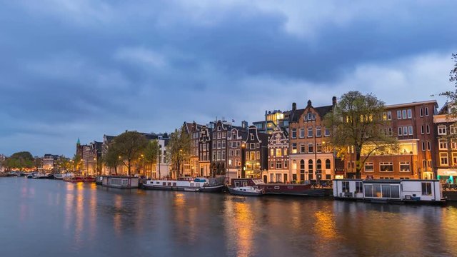 Amsterdam city skyline day to night timelapse at canal waterfront, Amsterdam, Netherlands, 4K Time Lapse