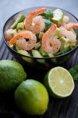 Close-up of avocado salad with shrimps and cucumber, selective focus