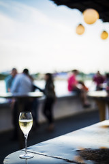 glass of champagne at modern outdoor bar at sunset