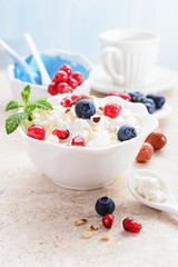 Cottage cheese with berries on light background.
