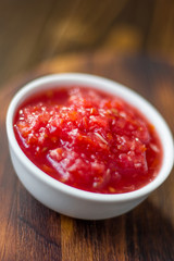 Indian chutney or mexican salsa in white ceramic bowl.