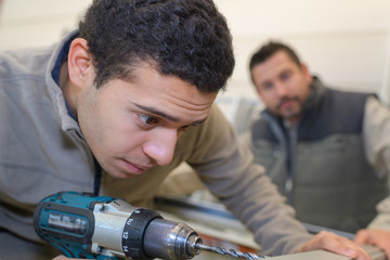 man drilling a hole