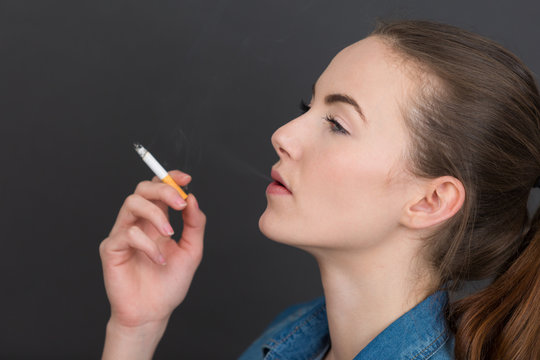 beautiful young woman enjoying her cigarette