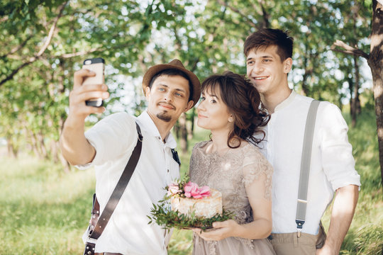 Wedding photographer, bride and groom make selfie in nature