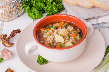 Vegan soup with pearl barley, vegetables and mushrooms