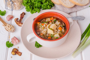 Vegan soup with pearl barley, vegetables and mushrooms