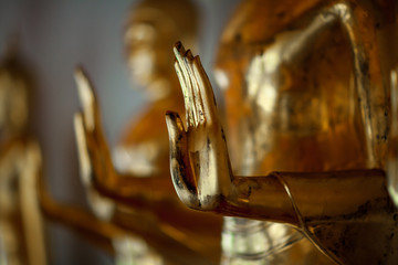 Gilded blessing hand of Buddha, close up of temple statue from Thailand