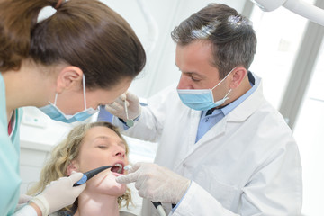 dentists examining a patients teeth in the dentist