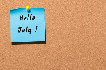 Hello July on blue sticker pinned to corc noticeboard with empty space for text