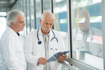 two doctors at hospital with clipboard