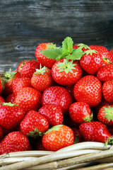Fresh red strawberry in a brown basket - healthy food concept
