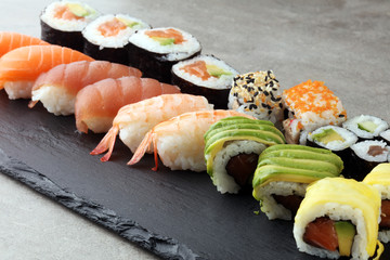 close up of sashimi sushi set with chopsticks and soy - sushi roll with salmon and sushi roll with smoked eel, selective focus.