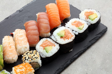 close up of sashimi sushi set with chopsticks and soy - sushi roll with salmon and sushi roll with smoked eel, selective focus.
